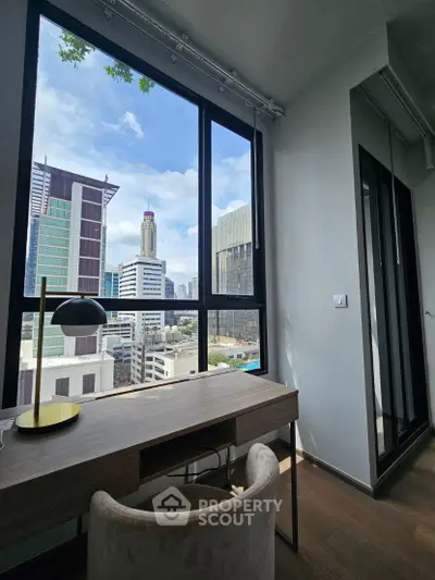 Modern study room with city view, featuring sleek desk and chair, large windows, and contemporary decor.