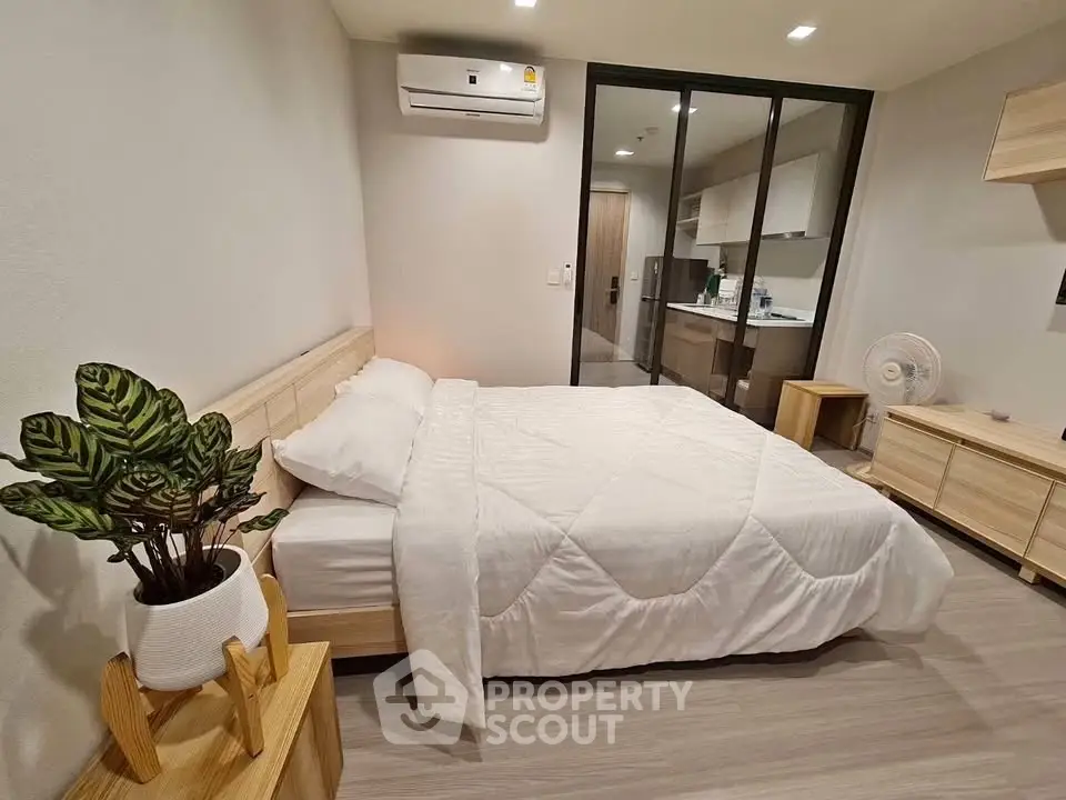 Modern bedroom with cozy bed and stylish decor in a contemporary apartment.