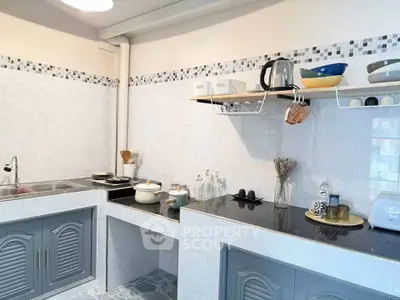 Charming kitchen with modern open shelving and sleek countertops, perfect for culinary enthusiasts.
