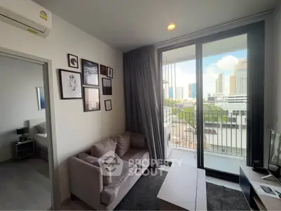Modern living room with city view, cozy sofa, and wall art in a stylish apartment.