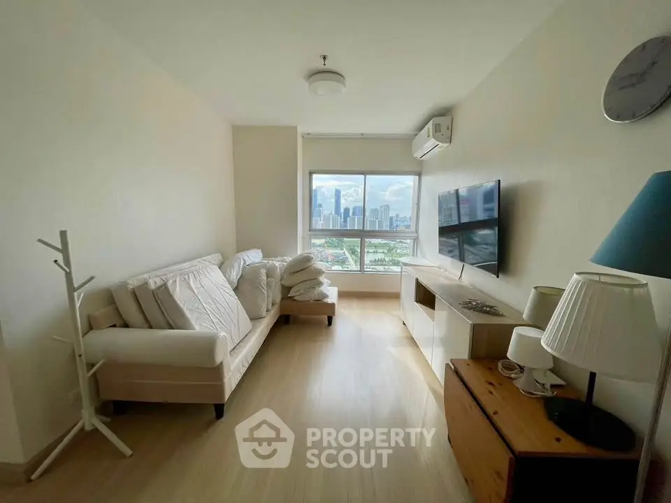 Bright living room with city view, modern furniture, and air conditioning in a high-rise apartment.