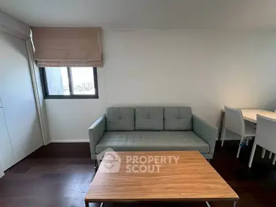 Modern living room with stylish sofa and wooden coffee table, perfect for cozy gatherings.
