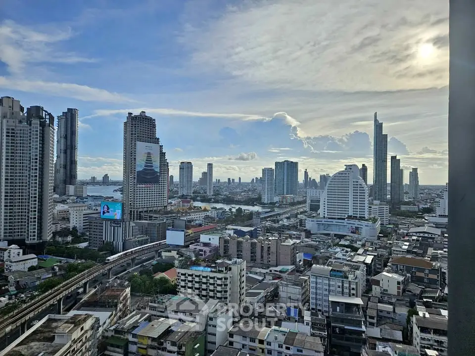 Stunning cityscape view from a high-rise building showcasing modern skyline and river.