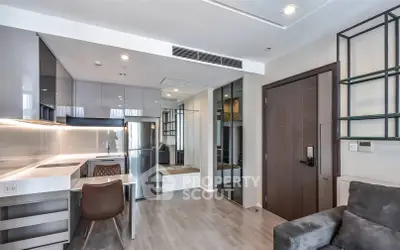 Modern open-plan kitchen and living area with sleek design and contemporary furnishings.