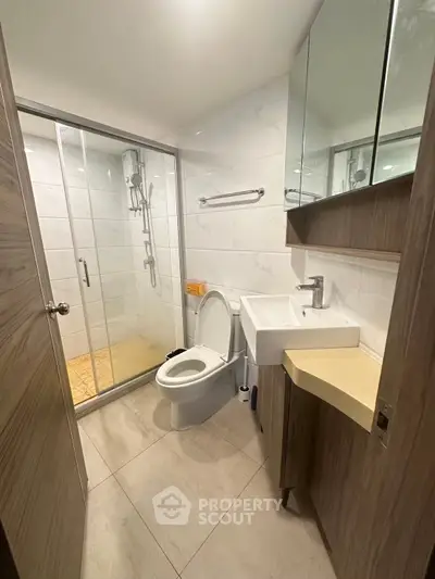 Modern bathroom with glass shower and sleek fixtures