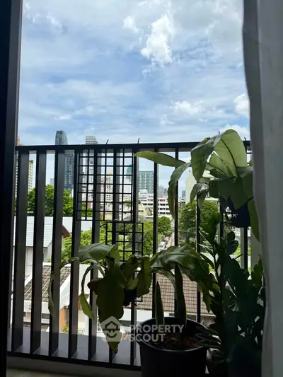 Charming balcony view with lush greenery and city skyline, perfect for urban living enthusiasts.