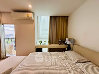Modern bedroom with balcony view, featuring stylish decor and ample natural light.