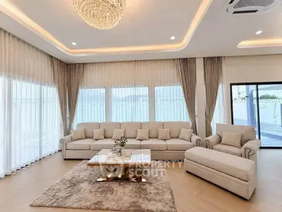 Luxurious living room with elegant chandelier and panoramic windows offering stunning views.