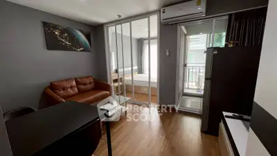 Modern apartment interior with sleek living room and bedroom, featuring stylish furniture and natural light.