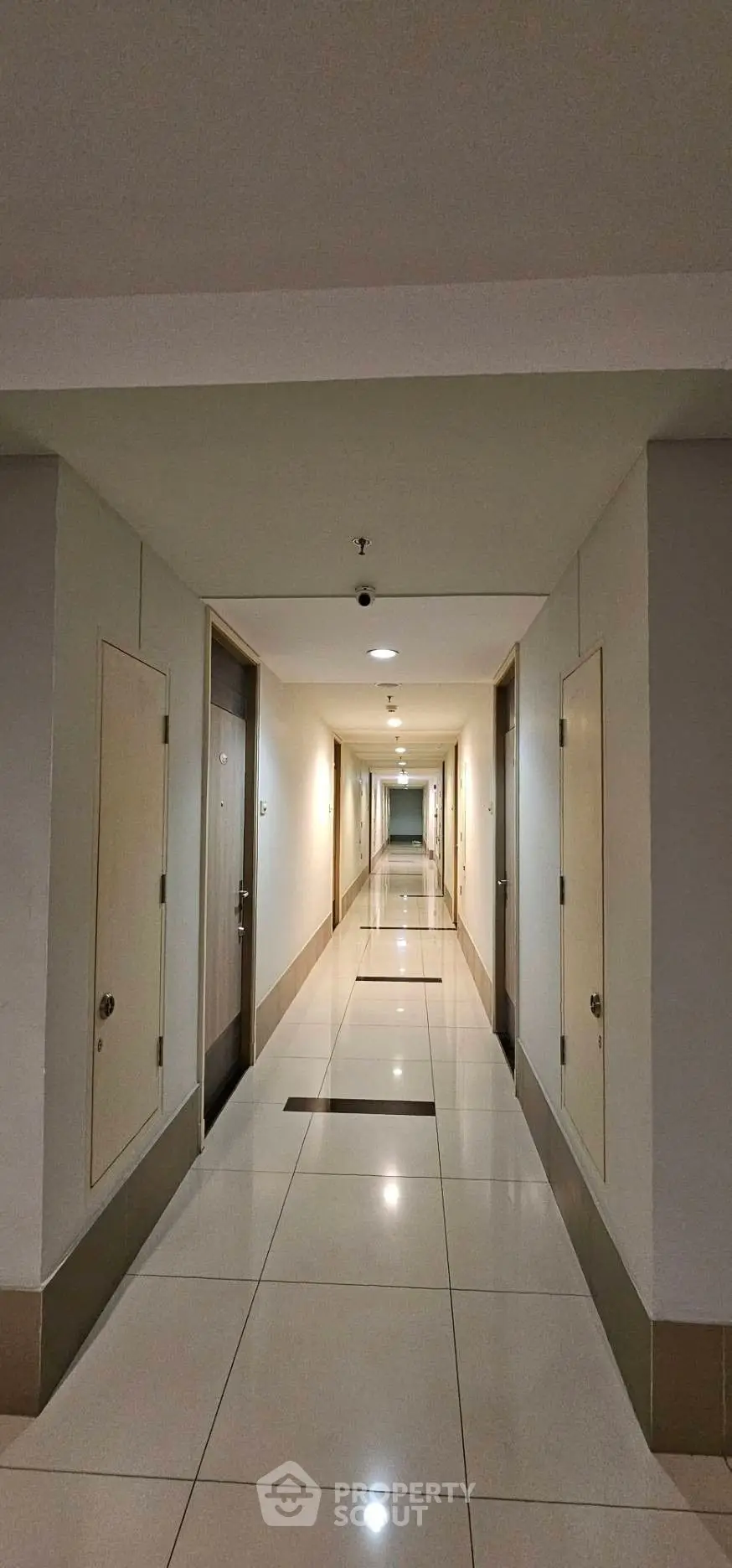 Modern apartment corridor with sleek design and polished tile flooring