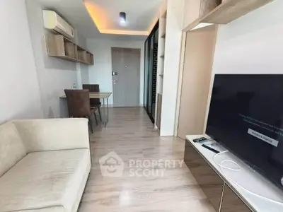 Modern living room with sleek design, featuring a cozy sofa and large TV, perfect for relaxation.