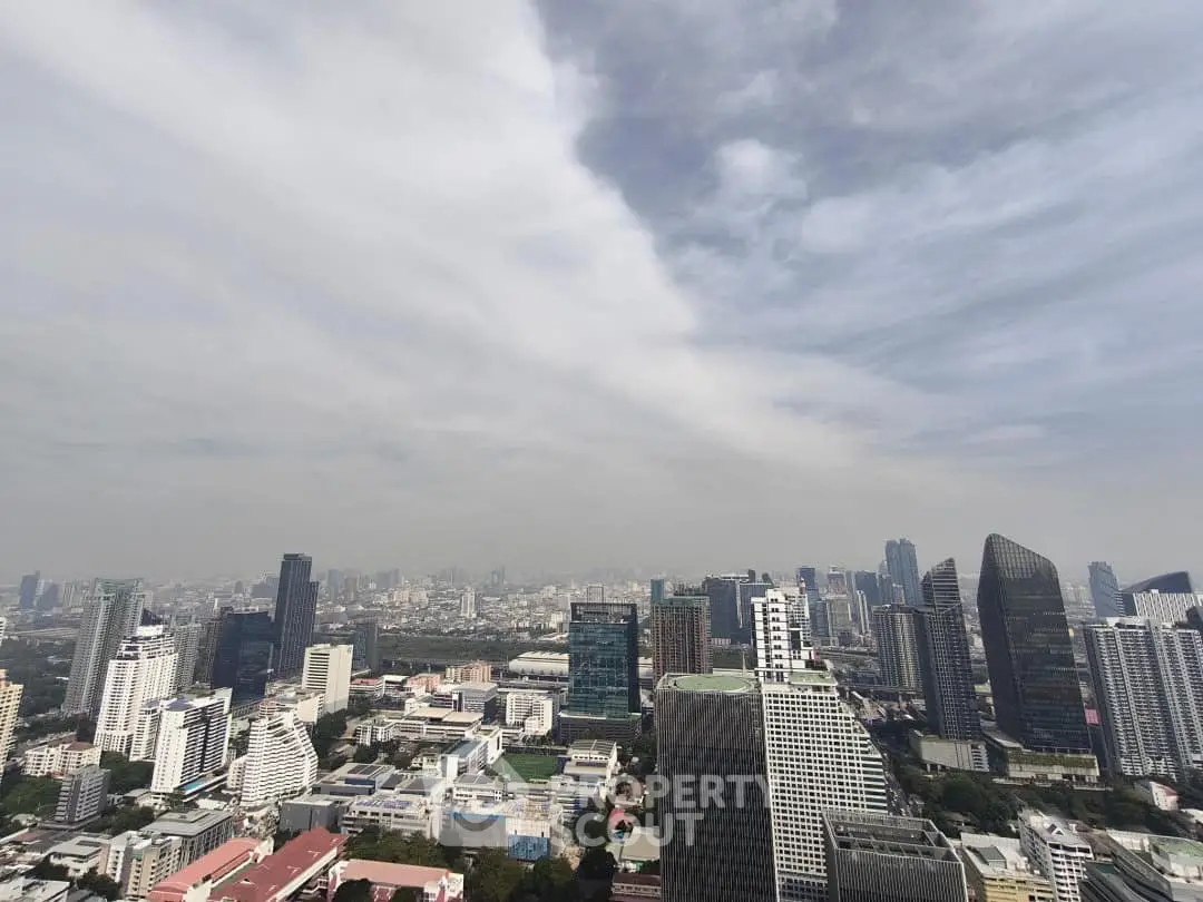 Stunning cityscape view showcasing modern skyscrapers and urban skyline under a cloudy sky.