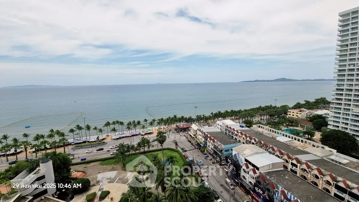 Stunning ocean view from high-rise building overlooking palm-lined beach and vibrant cityscape.