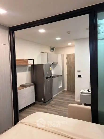 Modern studio apartment with sleek kitchen and cozy living area, perfect for urban living.