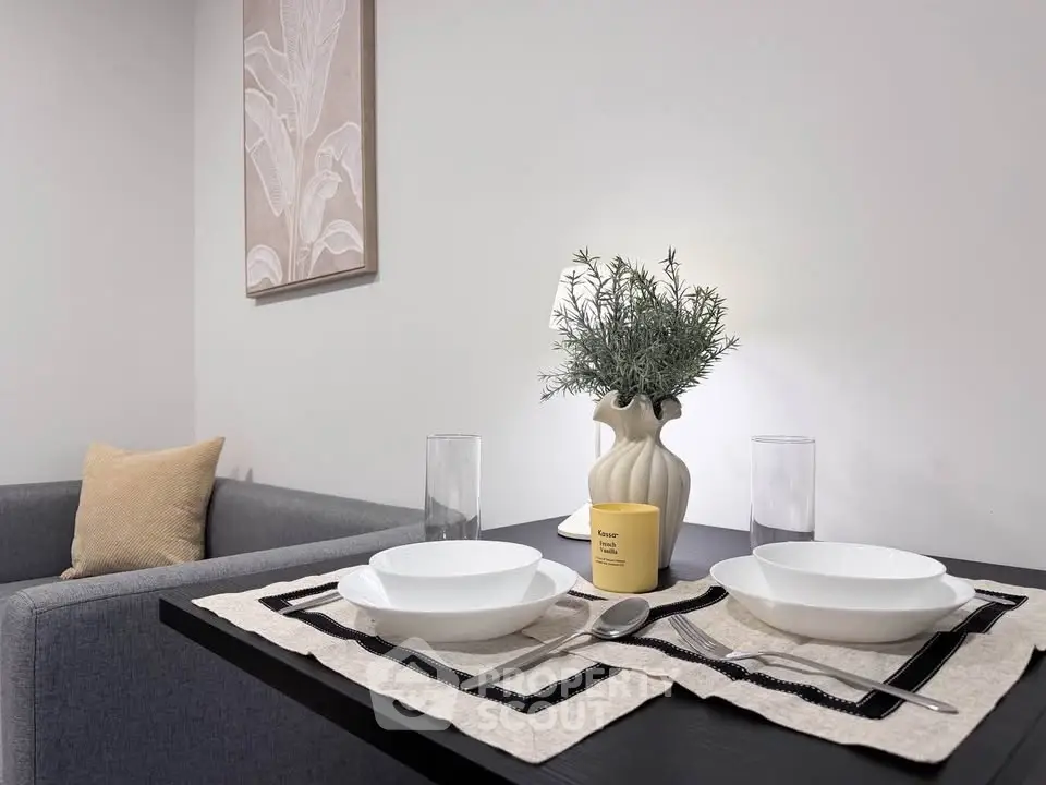 Modern dining setup with elegant tableware and cozy living room ambiance.