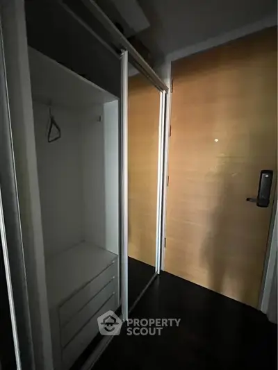 Compact entryway with mirrored closet and wooden door in modern apartment