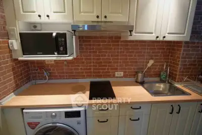 Charming kitchen with brick backsplash, modern appliances, and wooden countertops for a cozy home feel.