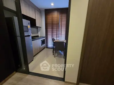 Modern kitchen with sleek appliances and dining area in stylish apartment