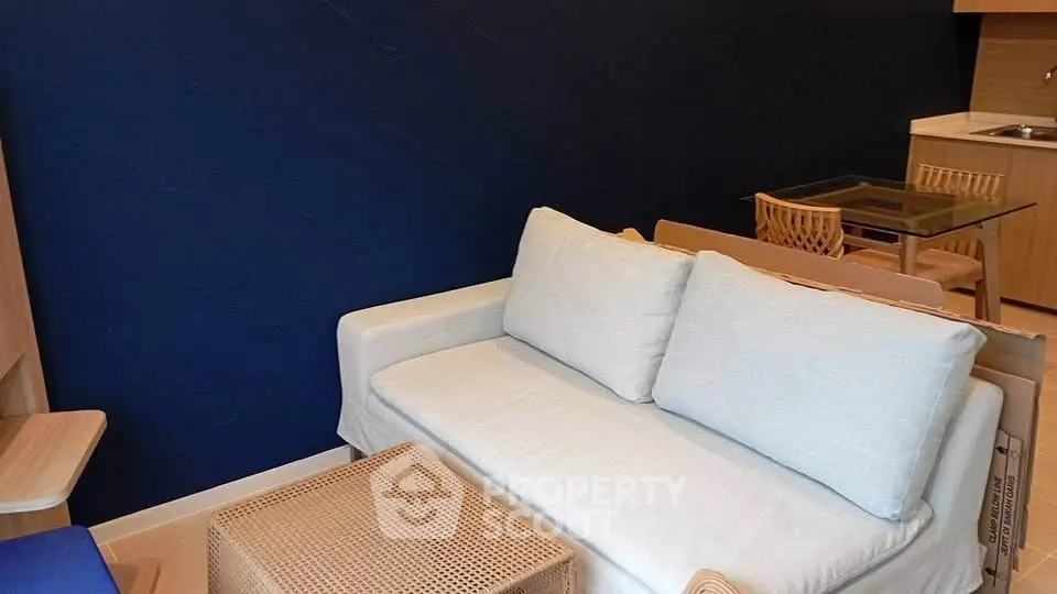 Modern living room with stylish furniture and open kitchen layout