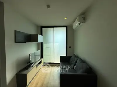 Modern living room with sleek furniture and air conditioning