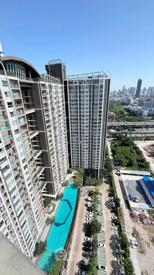 Stunning high-rise building with pool and city view, perfect for urban living.