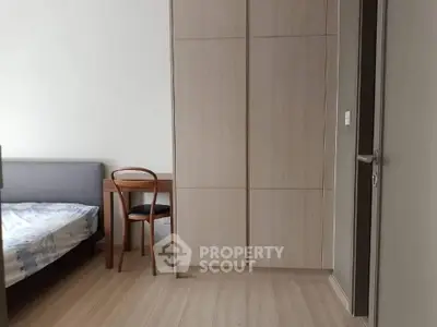 Modern bedroom with wooden flooring and minimalist furniture design