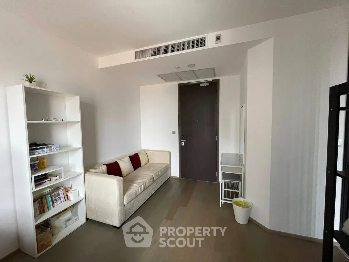Modern living room with minimalist decor and cozy sofa in a stylish apartment.