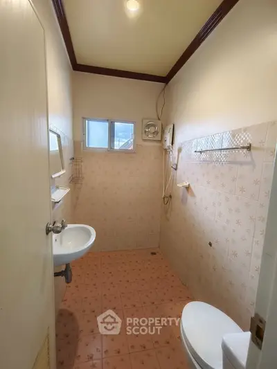 Compact bathroom with vintage tiles and modern fixtures