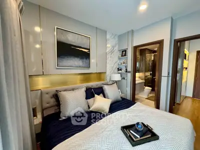 Luxurious bedroom with elegant decor and ensuite bathroom in modern apartment