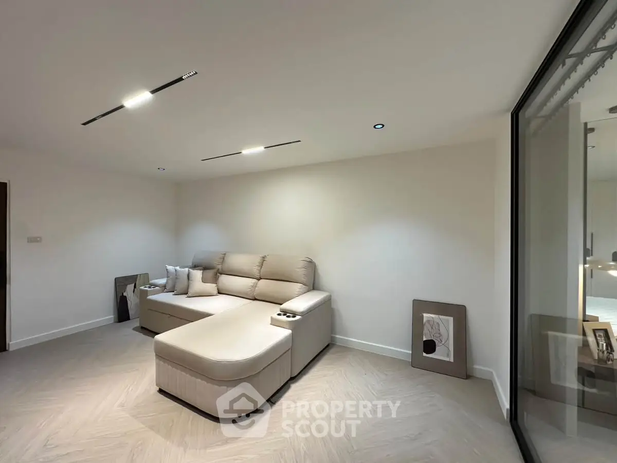 Modern living room with stylish sectional sofa and minimalist decor, perfect for relaxation and entertainment.
