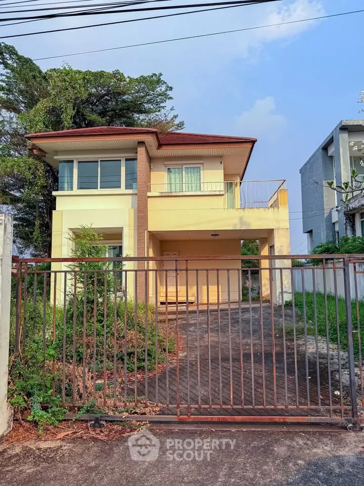 Charming two-story house with spacious driveway and lush greenery, perfect for family living.