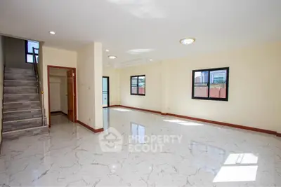 Spacious modern living room with marble flooring and natural light