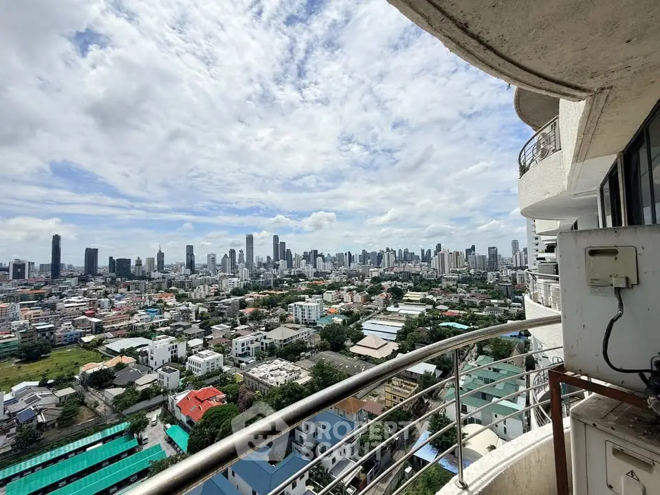 Stunning cityscape view from a high-rise balcony with modern railing and expansive skyline.