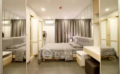 Modern bedroom with mirrored walls and stylish decor