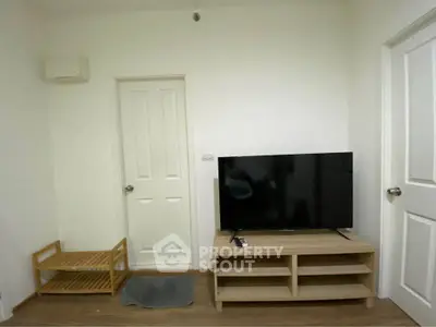 Cozy living room with modern TV setup and minimalist decor