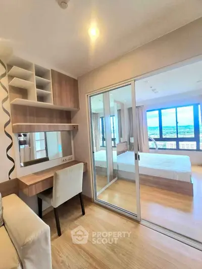 Modern bedroom with study area and large windows offering stunning views.