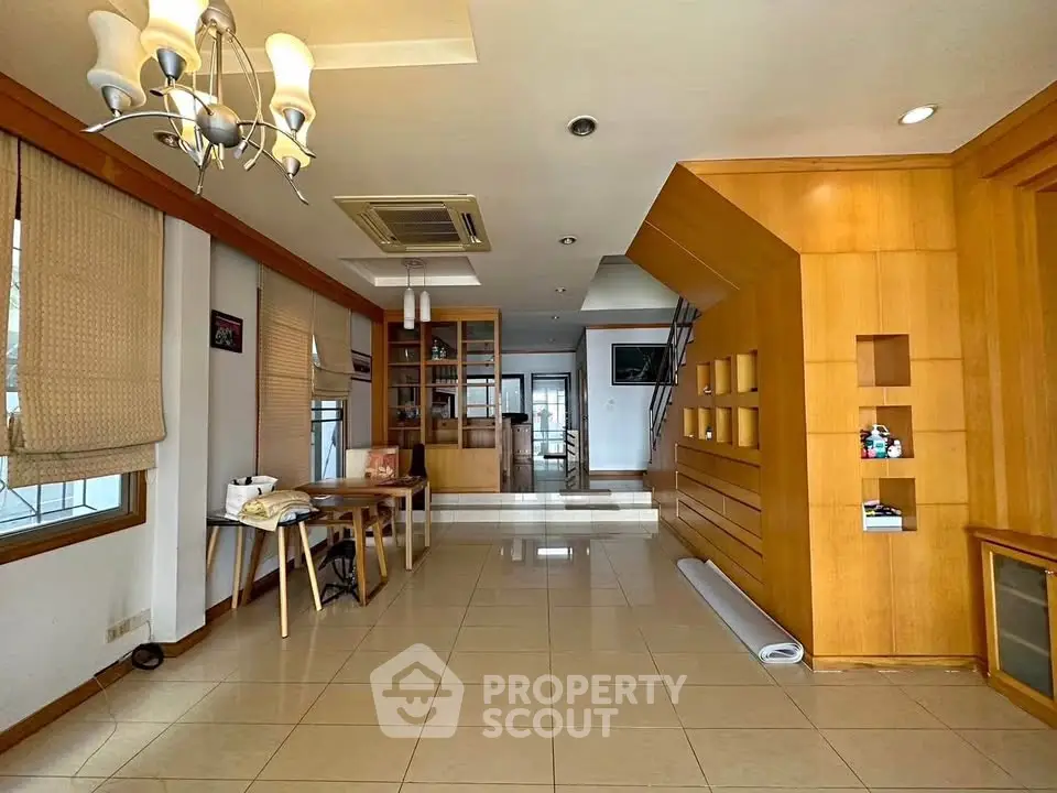 Spacious living room with modern wooden accents and elegant lighting