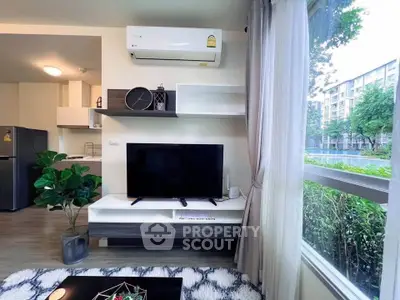 Modern living room with large window, air conditioning, and stylish decor in a contemporary apartment.
