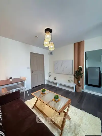 Modern living room with stylish decor and natural light, featuring a cozy seating area and elegant lighting.