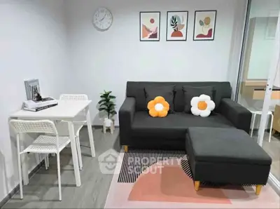 Modern living room with stylish decor, featuring a cozy sofa, chic artwork, and a compact dining area.