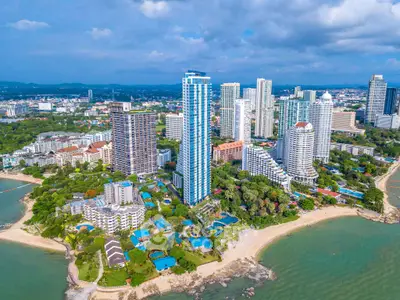 Stunning beachfront high-rise buildings with lush greenery and ocean views.