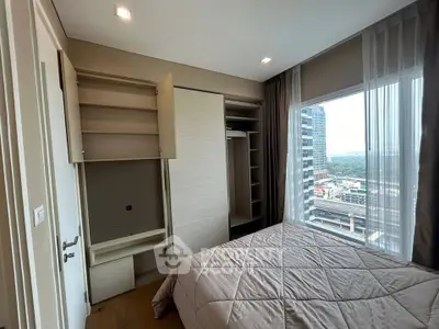 Modern bedroom with city view and built-in wardrobe