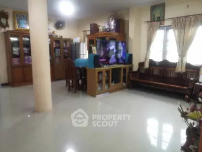 Spacious living room with elegant wooden furniture and large windows for natural light.