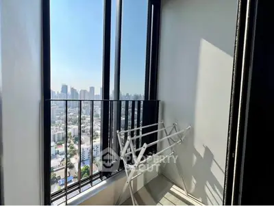Stunning city view from a high-rise balcony with ample natural light.