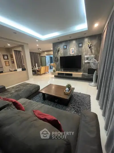 Spacious modern living room with stylish decor and cozy seating area.