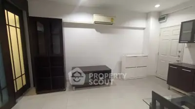 Modern living room with sleek furniture and air conditioning unit, perfect for comfortable living.