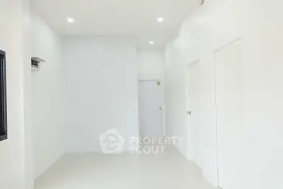 Spacious minimalist interior with white walls and modern lighting