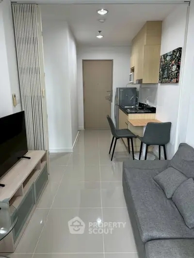 Modern apartment interior with sleek kitchen and cozy living area, perfect for urban living.