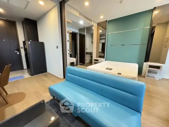 Modern studio apartment with blue sofa and stylish decor