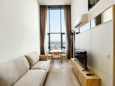 Modern living room with high ceilings and large windows offering stunning views.